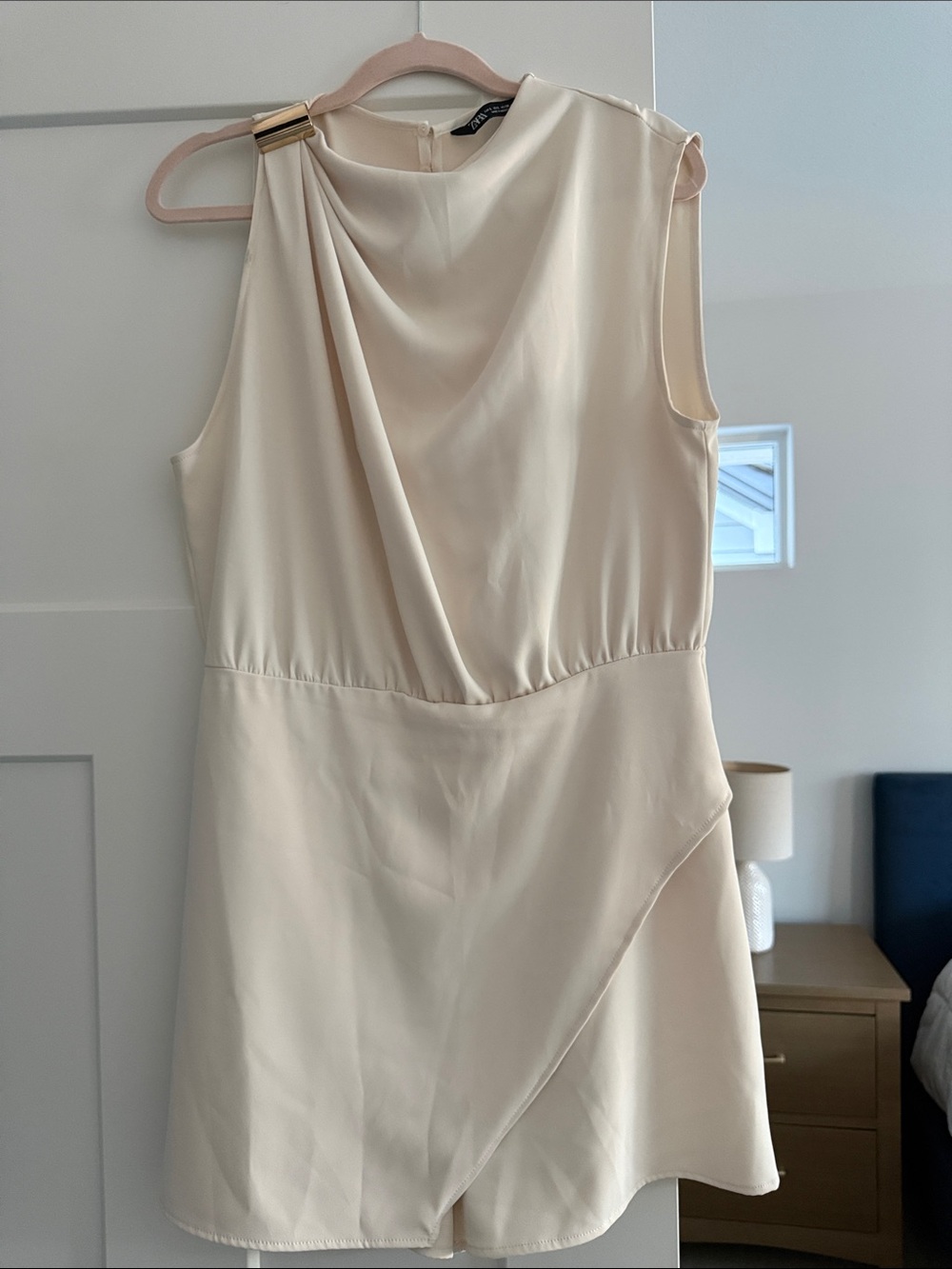 Short jumpsuit with gold appliqué at shoulder